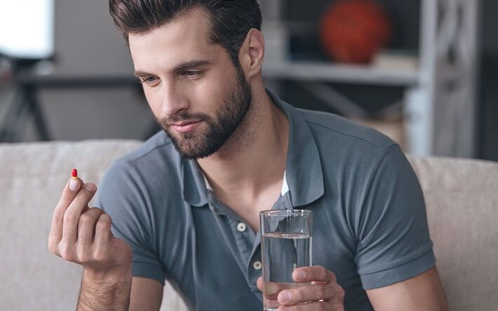 a man drinks a pill to enlarge the head of his penis